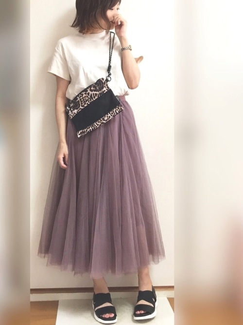 白いスムースTにヒョウ柄バッグを合わせた女性