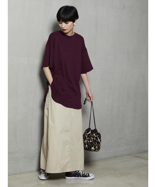 ボルドーTシャツにロングスカートを着た女性