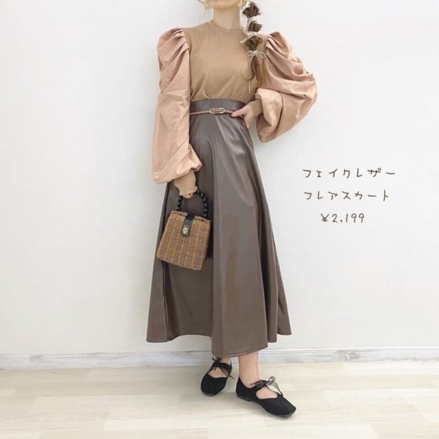 ブラウンの異素材ボリューム袖トップスにフェイスフレアスカートと黒のバレエシューズとカゴバッグを合わせたコーデ