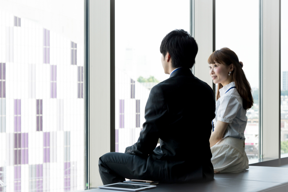 窓際で話している男女